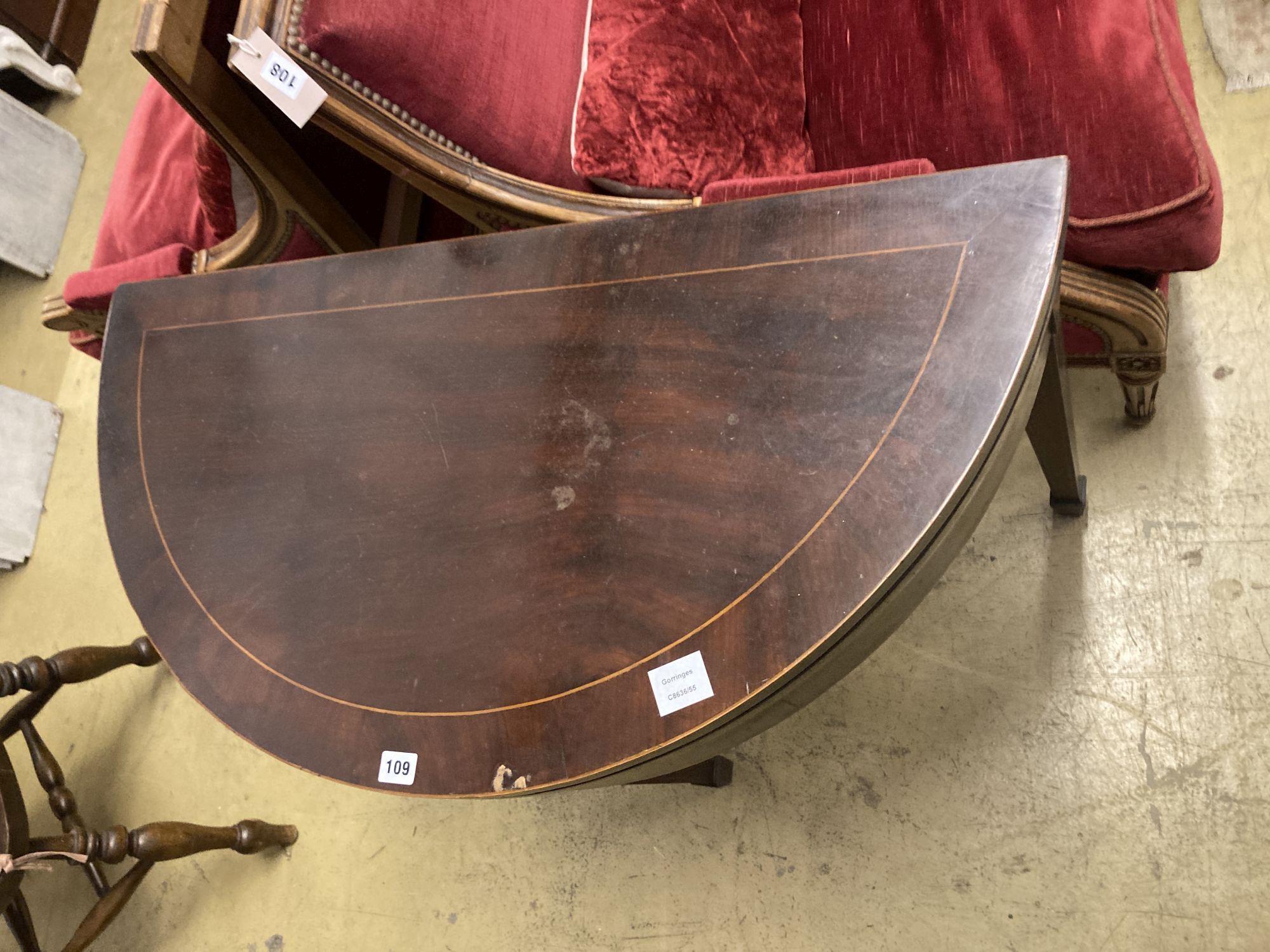 A George III style inlaid mahogany D shaped folding card table, width 92cm, depth 46cm, height 76cm